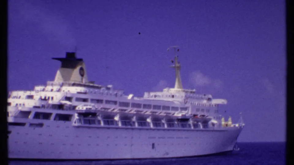 1969 Bahamas 8mm frame with a closer view of the cruise ship's forward decks, rows of windows, lifeboats, and funnel.