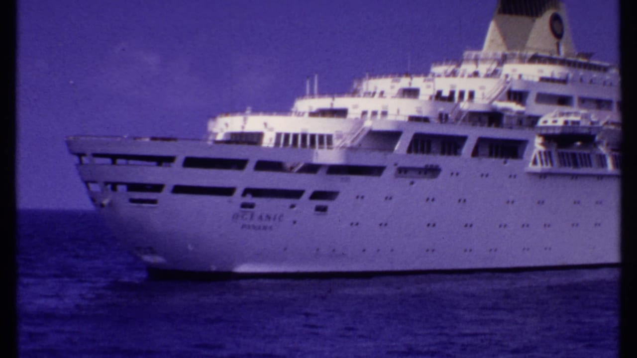 Closer view of a white passenger ship's bow and upper decks at sea.