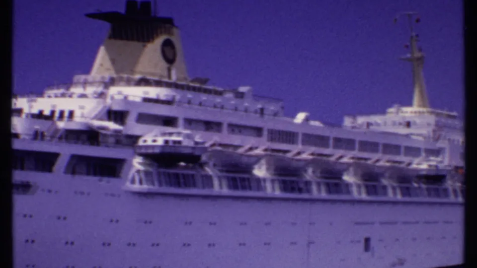 1969 Bahamas frame with the Oceanic Panama cruise ship filling the view, showing funnel, lifeboats, rows of windows, and mast.