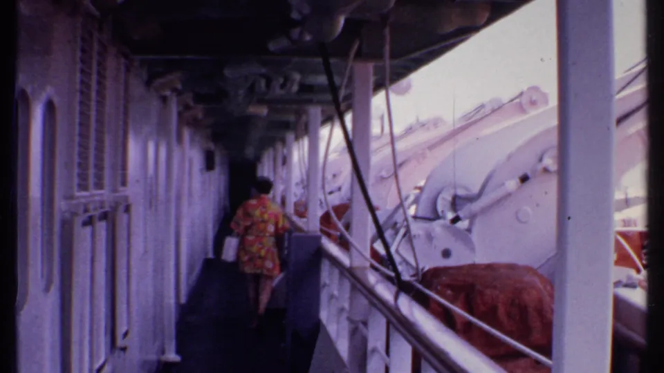 At the end of the short 1969 Bahamas shot, the woman walks away through the ship corridor with railings and deck equipment around her.