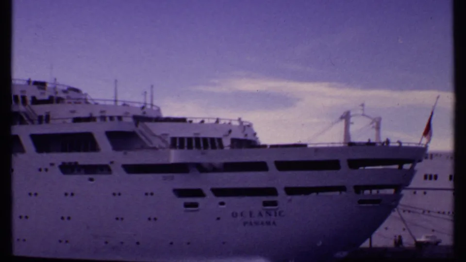 1969 Bahamas frame showing the stern section of the white cruise ship with OCEANIC PANAMA lettering, deck railings, and a flag.