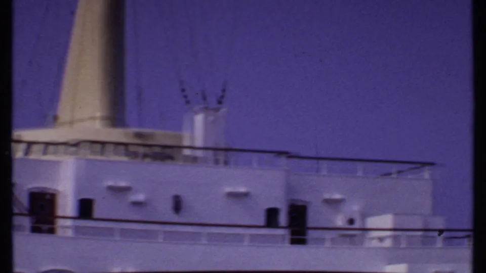 A closer view shows the ship funnel, upper deck railings, and white exterior surfaces in Bahamas 1969 home-movie footage.