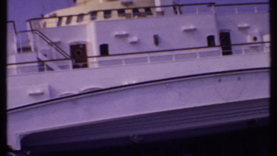 1969 Bahamas cruise footage showing white ship decks, railings, and upper structures under a purple-tinted sky.