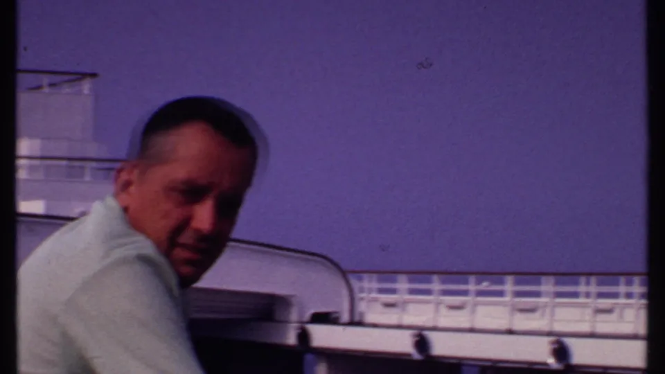 A man in a pale shirt looks toward the home-movie camera aboard a 1969 Bahamas cruise ship.