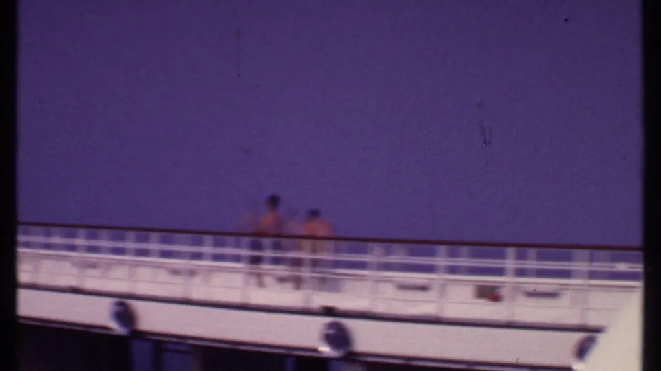 Distant passengers appear on a white cruise ship deck in 1969 Bahamas home-movie footage.