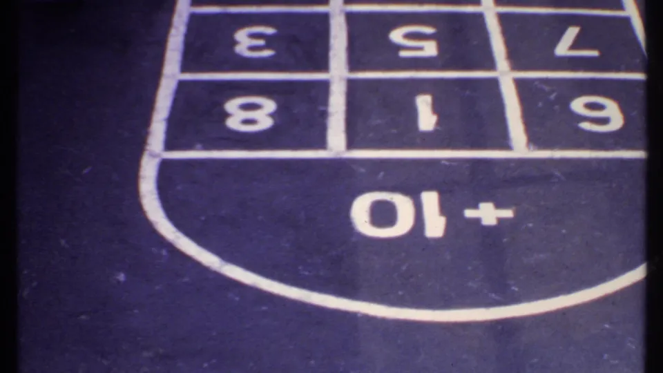 Close-up of the ship-deck shuffleboard grid with large painted numbers and scoring markings.