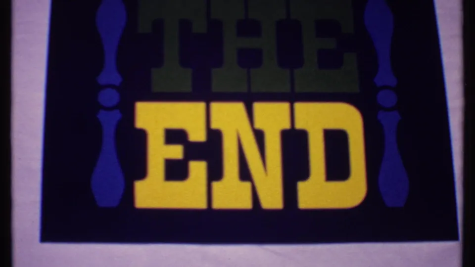Decorative 1960s-style home-movie end card with large yellow “THE END” lettering and blue side ornaments.