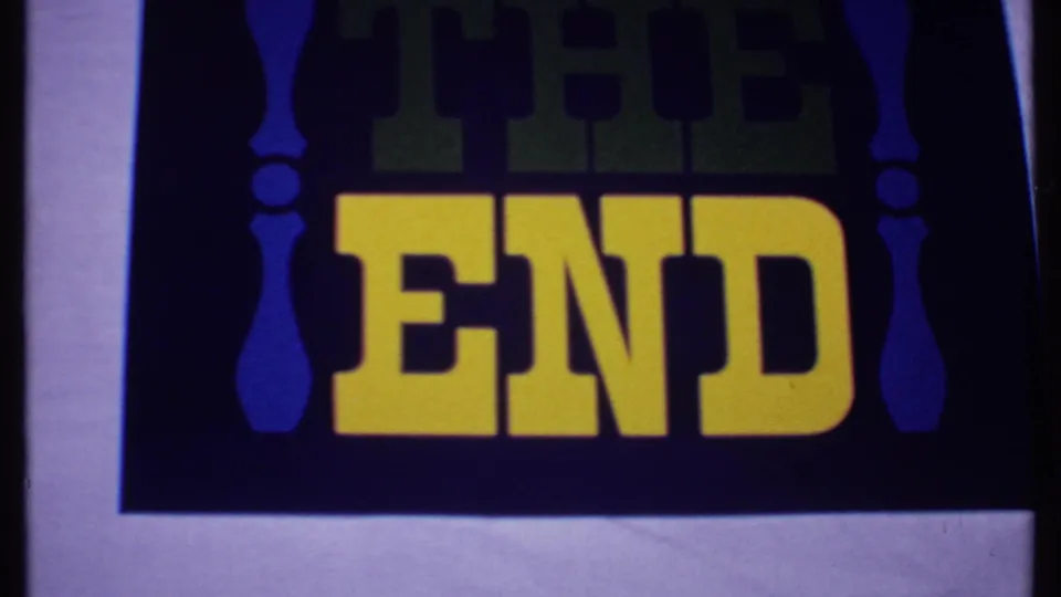 1969 Bahamas 8mm frame repeating the THE END title card, with visible grain, slight flicker, and dark printed background.