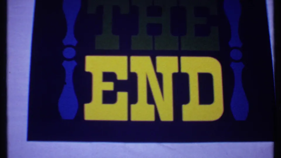 1969 8mm Bahamas reel frame with the THE END card shifted slightly, showing yellow text, dark blue field, and pale border.
