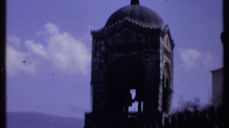 1969 Kenya 8mm frame showing a church bell tower or arched structure silhouetted against a purple-blue sky.