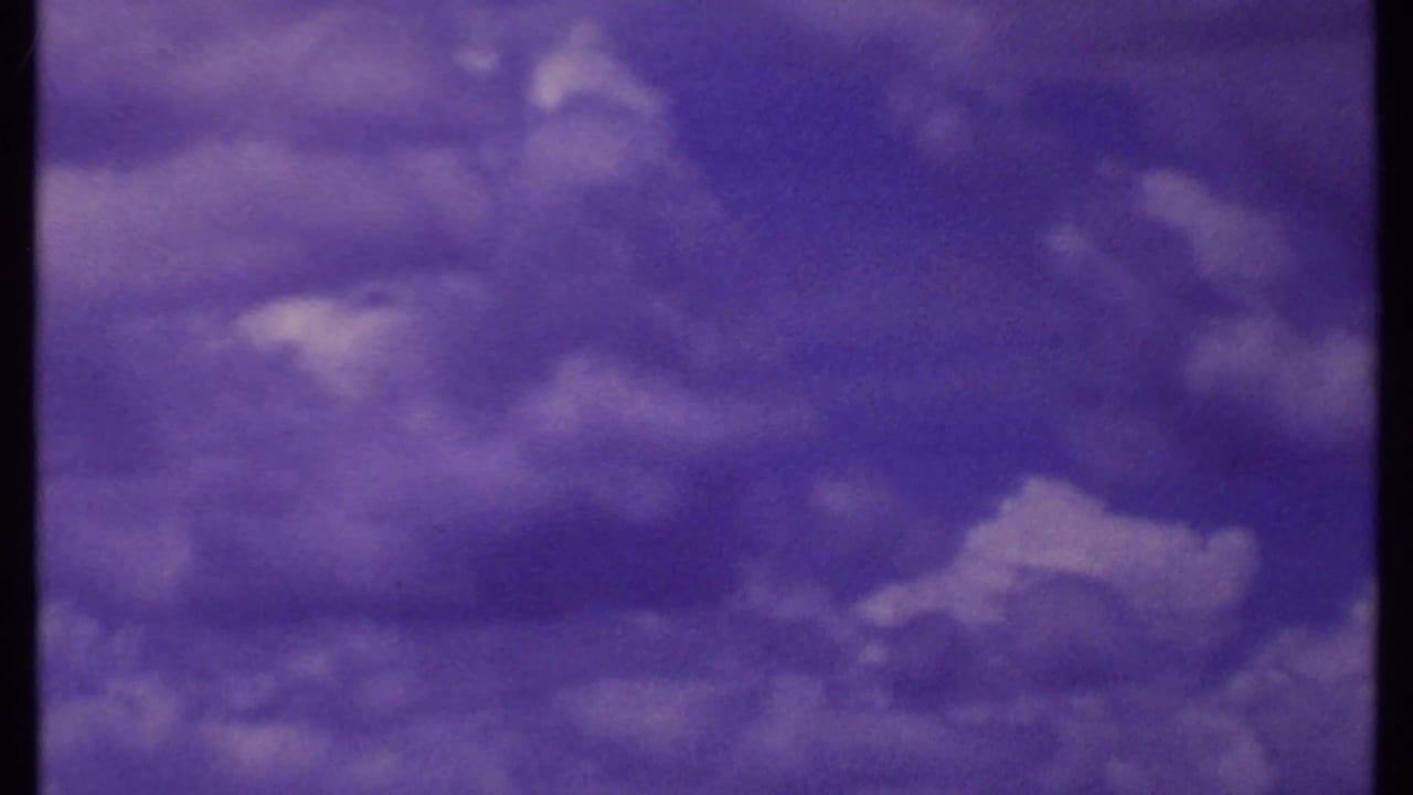 Cloud-filled purple sky over a dark low horizon with little foreground detail.