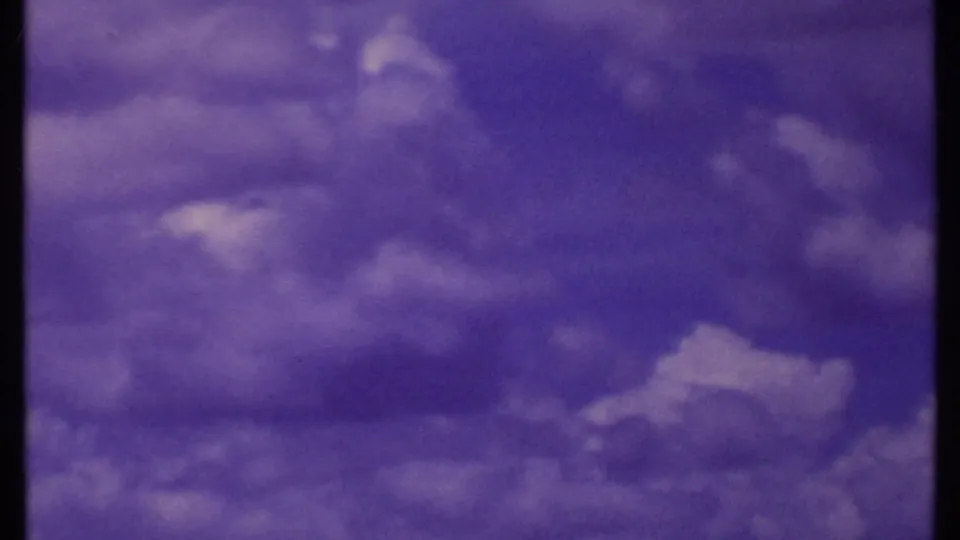 1969 Kenya 8mm frame emphasizing a purple-tinted sky above a low savanna horizon.