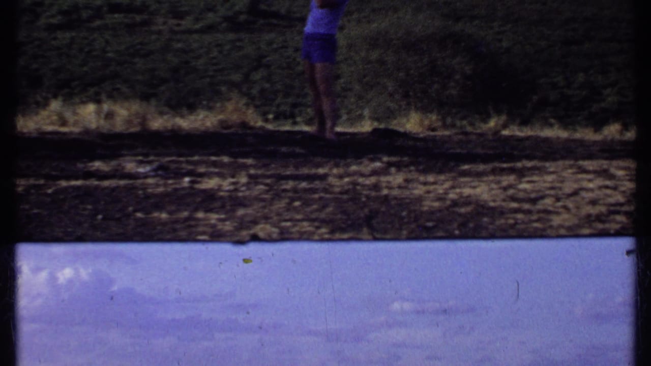 1969 Kenya 8mm frame dominated by cloudy sky, distant plains, and dark contact-sheet borders.