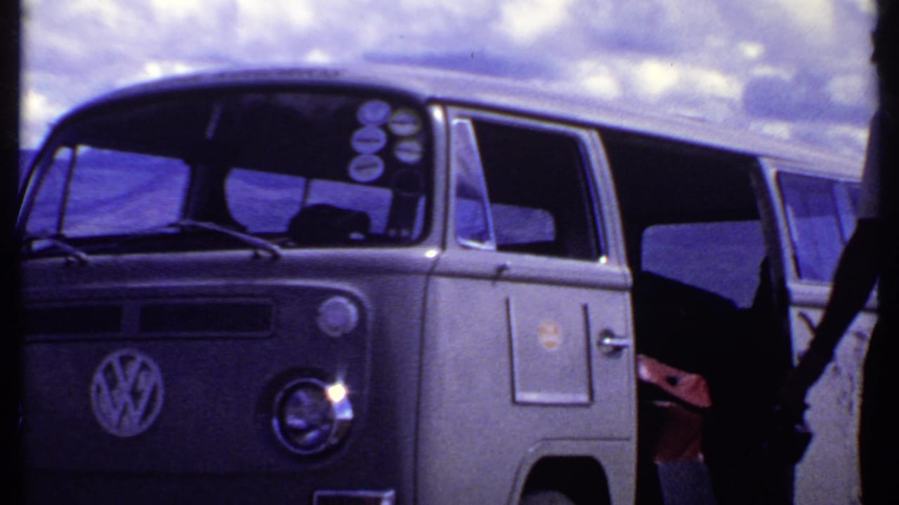 Kenya 1969 frame showing a Volkswagen bus with its side door open and a person partly visible near the doorway.