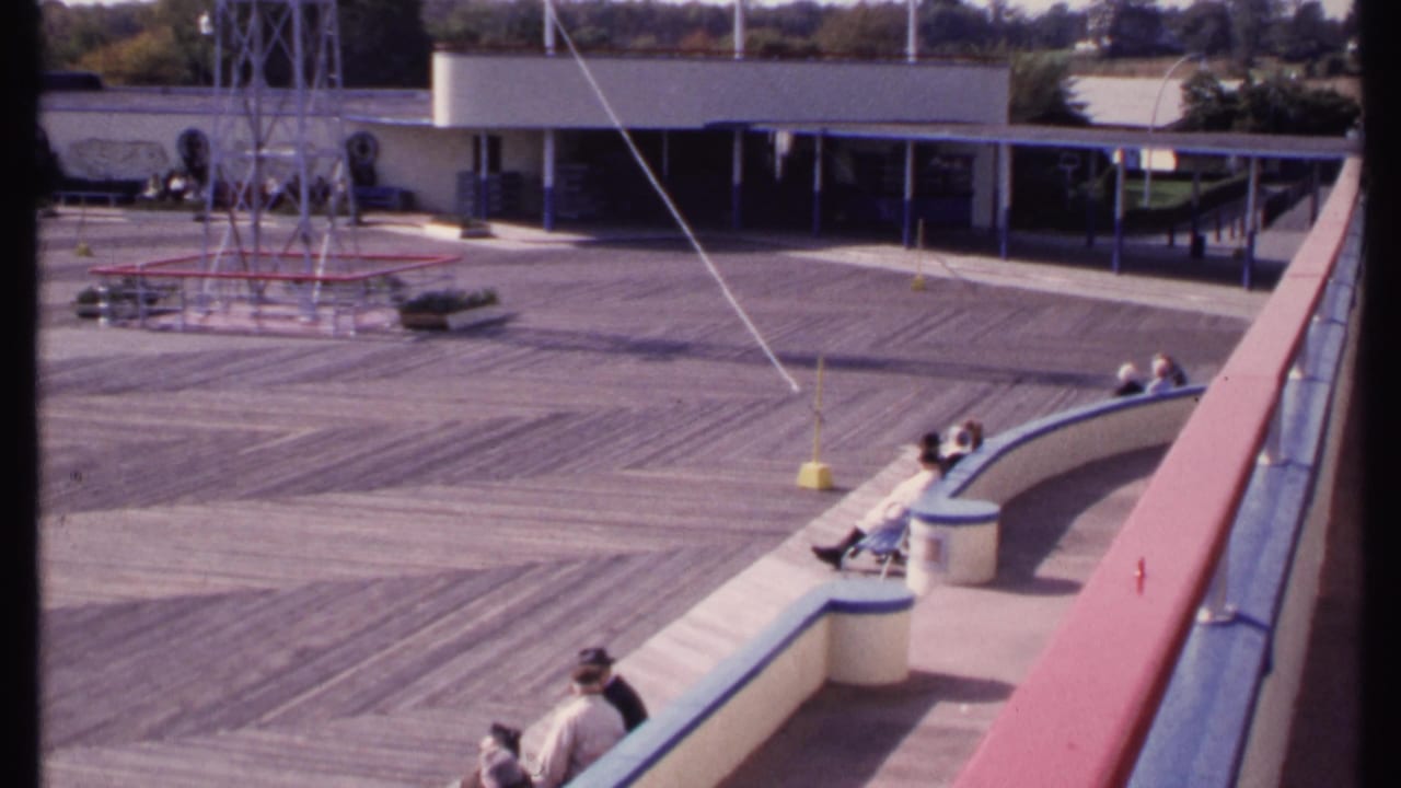 A similar elevated view shows seated people, a curved bench, deck boards, and a tower structure.