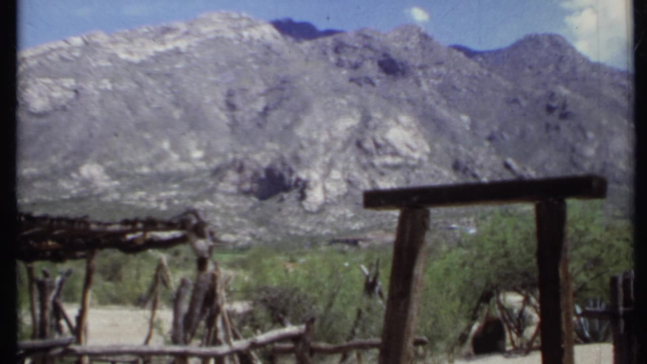 Wooden rails and shade posts with mountains across the background.