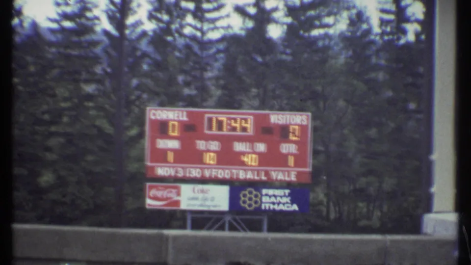 Closer 1979 Ithaca scoreboard view with Cornell, visitors, clock numbers, down and yardage panels, and brand signage.