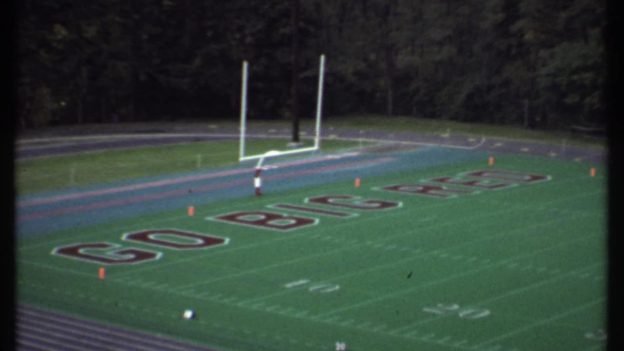 Football end zone with goalposts and large lettering reading GO BIG RED.