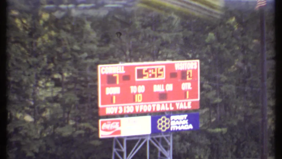 Zoomed 1979 Ithaca view of the red Cornell football scoreboard showing a 7-0 score and 5:45 on the clock.