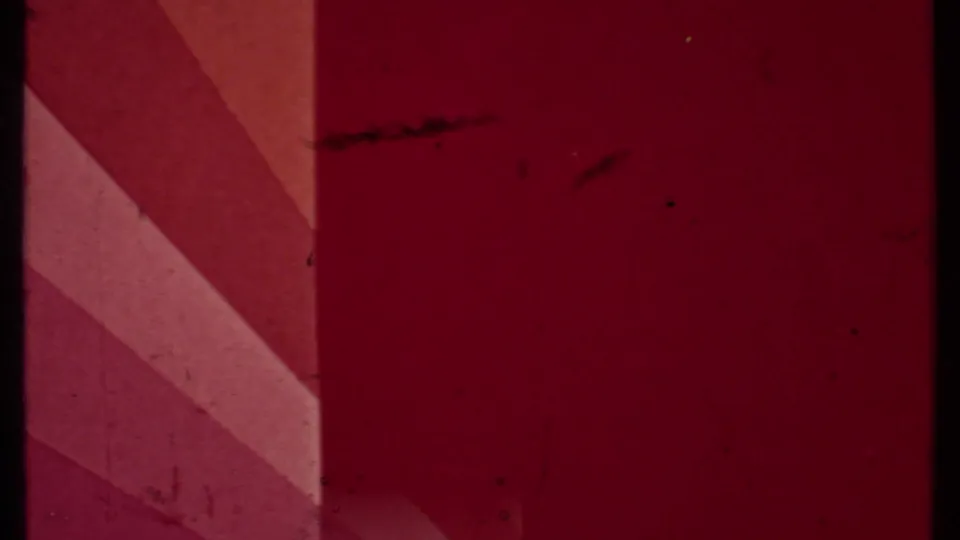 End frame from the 8mm scan showing a red-tinted obstructed or leader-like area with scratches and no identifiable scene detail.
