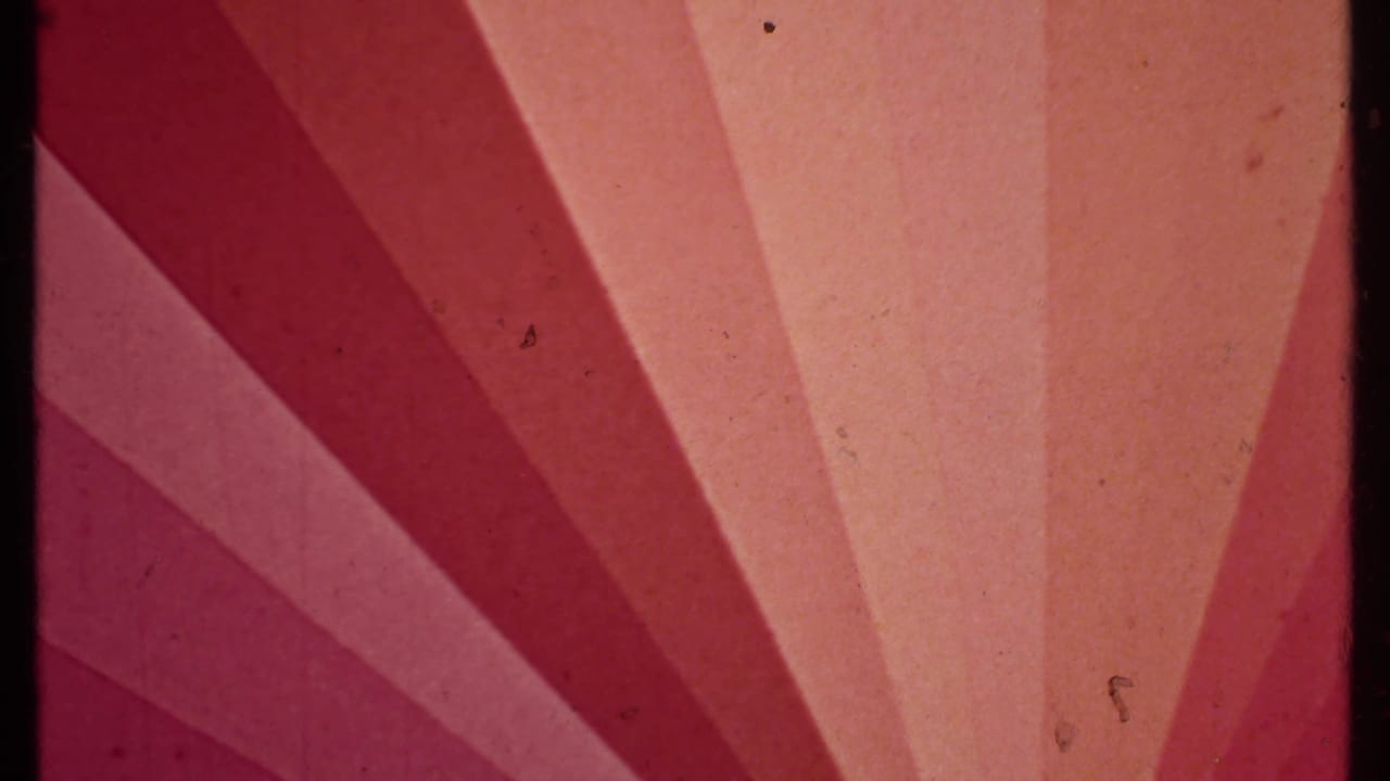 Magenta and orange abstract film exposure with radiating bands and visible grain.