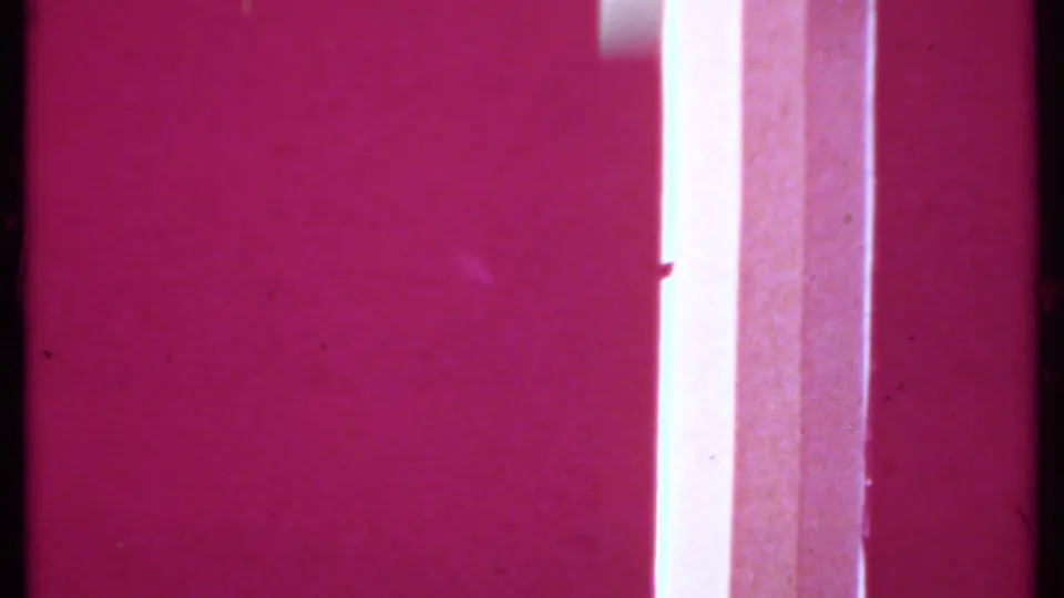 Overexposed magenta 8mm transition frame with a bright vertical strip and visible film texture.