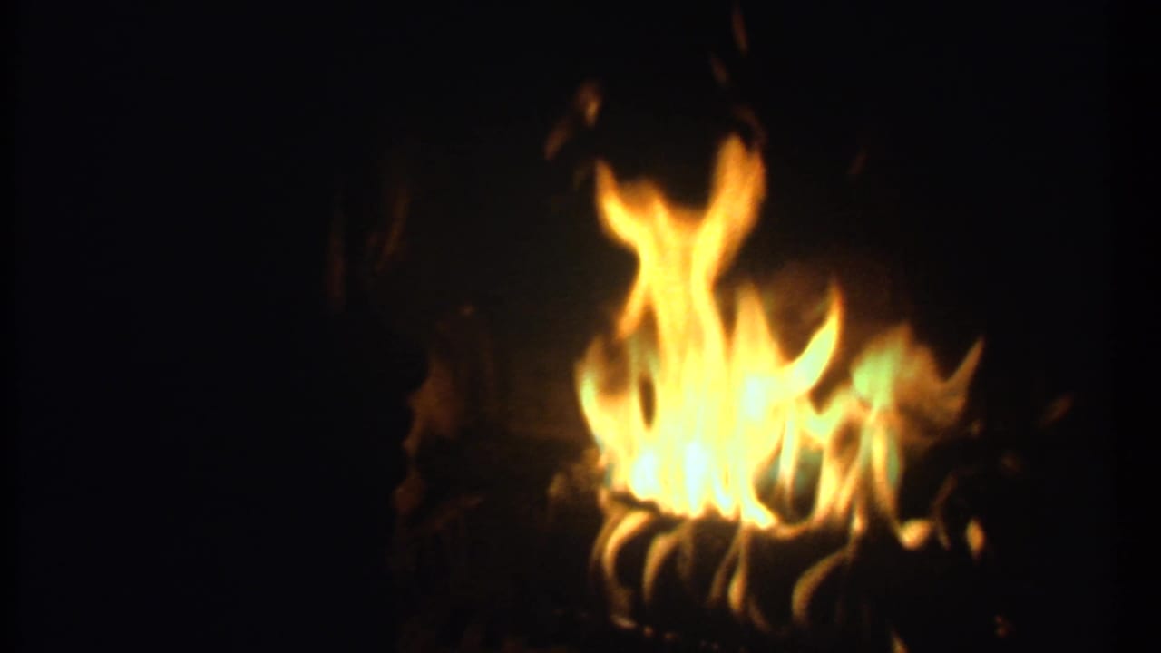Orange-yellow flames burning against a nearly black background.