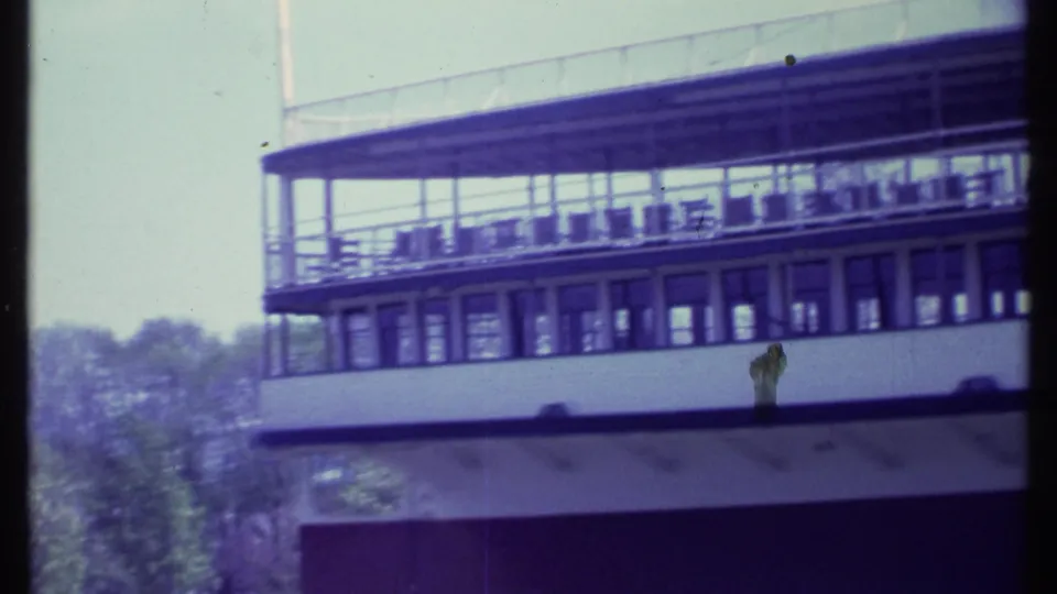 The white passenger boat appears from a slightly wider angle, with upper deck railings, windows, and trees behind it in Vermont footage.