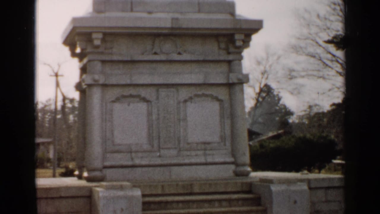 Stone pedestal centered outdoors with steps beginning to appear below.