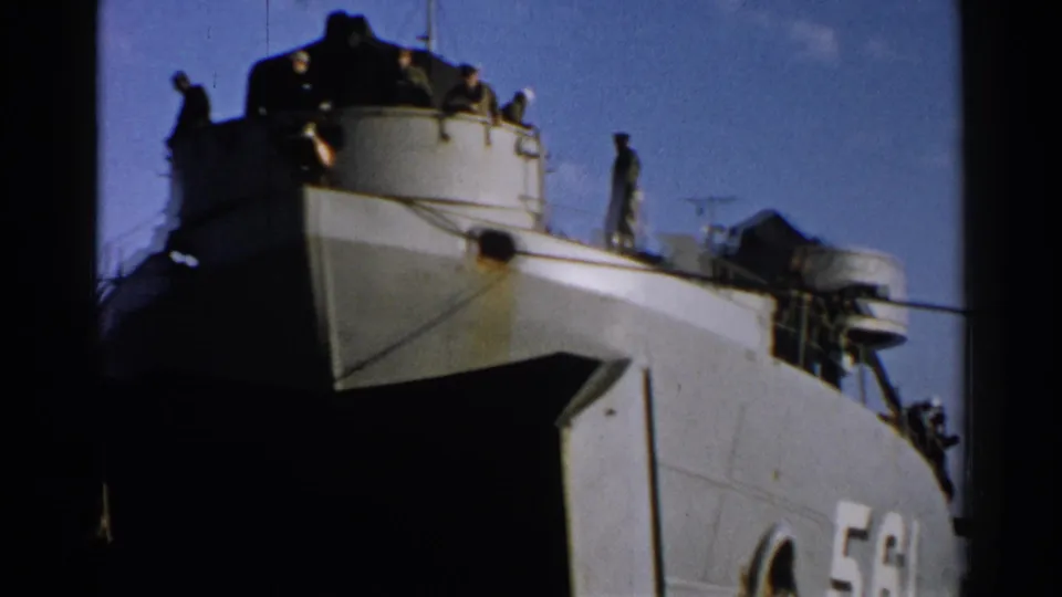Japan 1952 archival frame showing a military-looking vessel marked 561 with men standing on the superstructure and deck.
