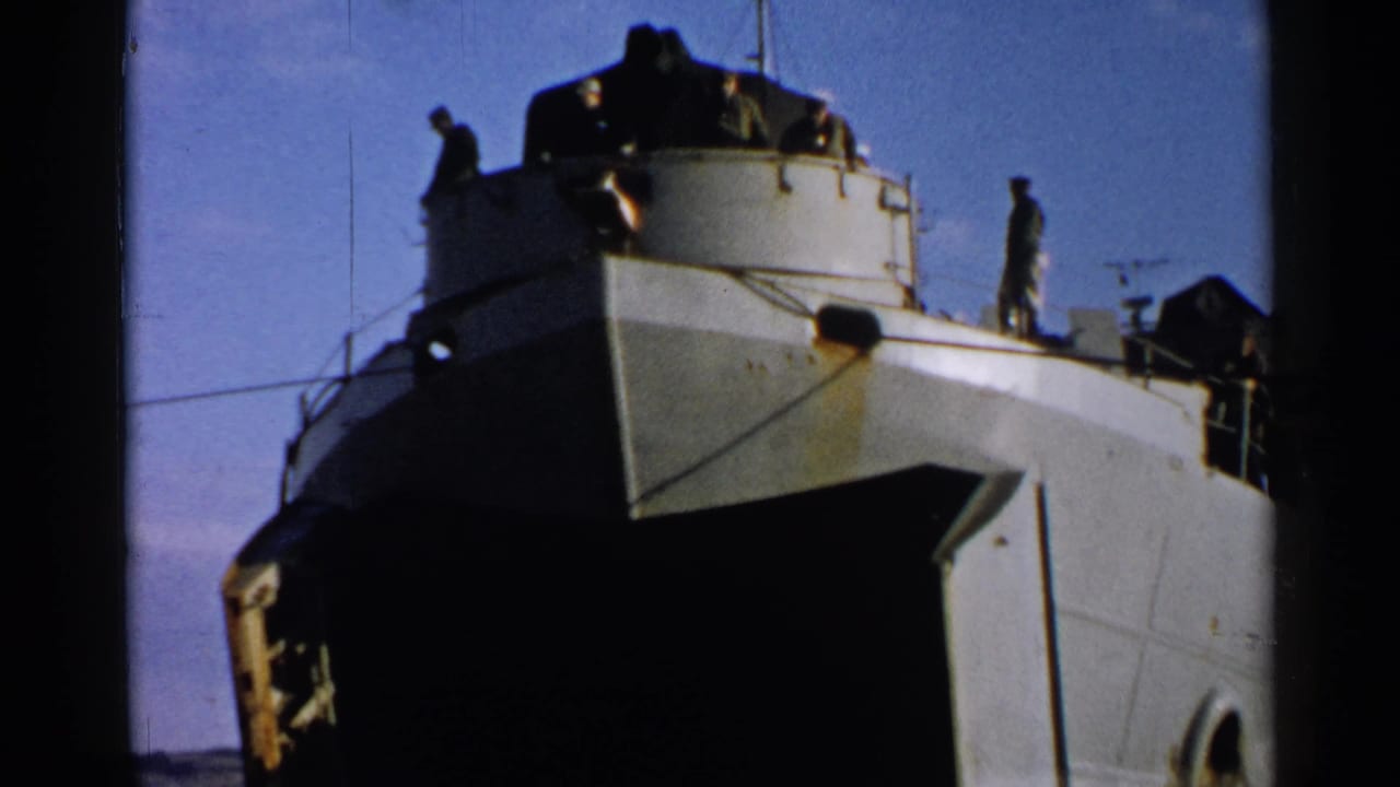 Naval-style ship bow with several crew members standing on the upper deck.