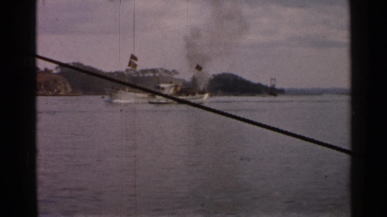 Smoking boat on calm water seen through a dark window frame and diagonal cable.