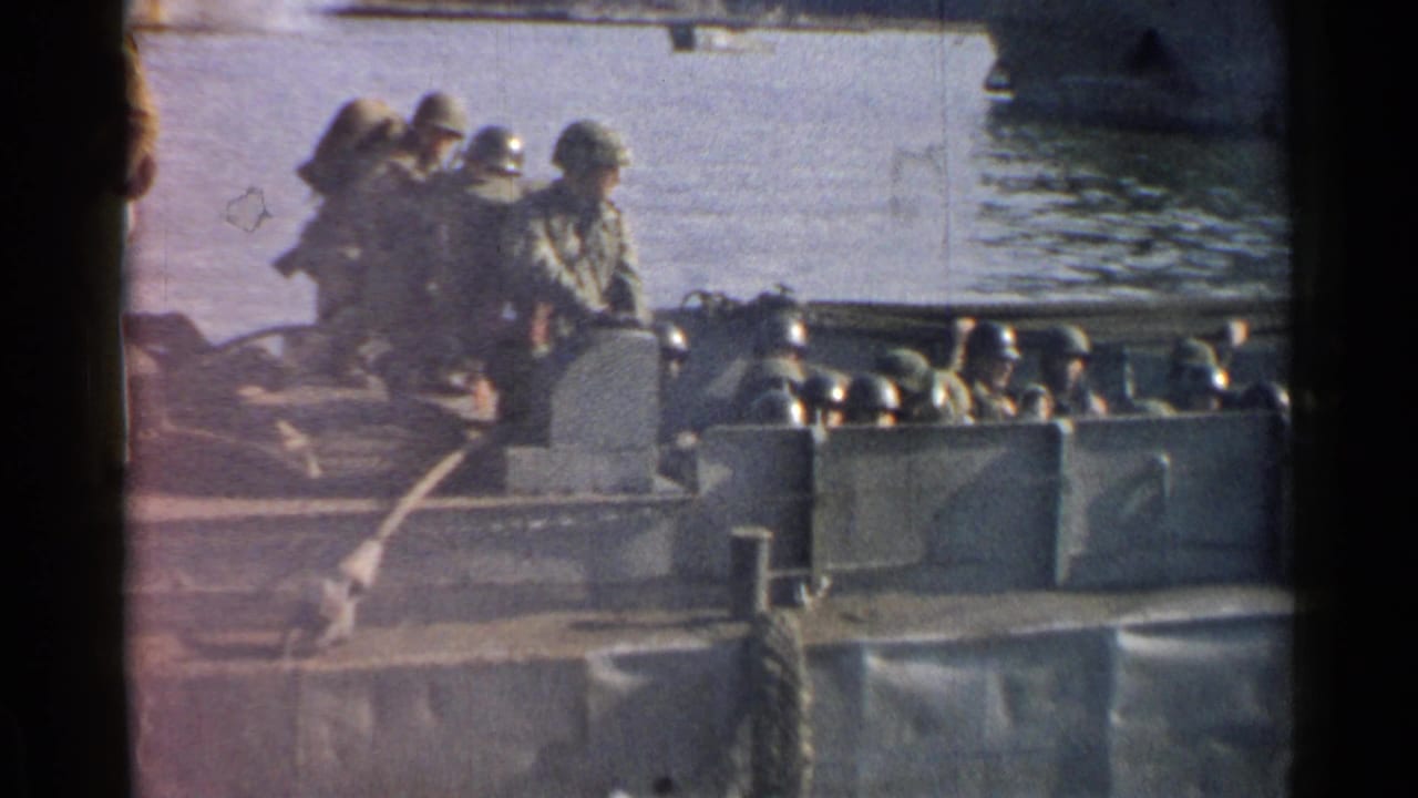 Soldiers in helmets move across the ferry deck near the river surface.