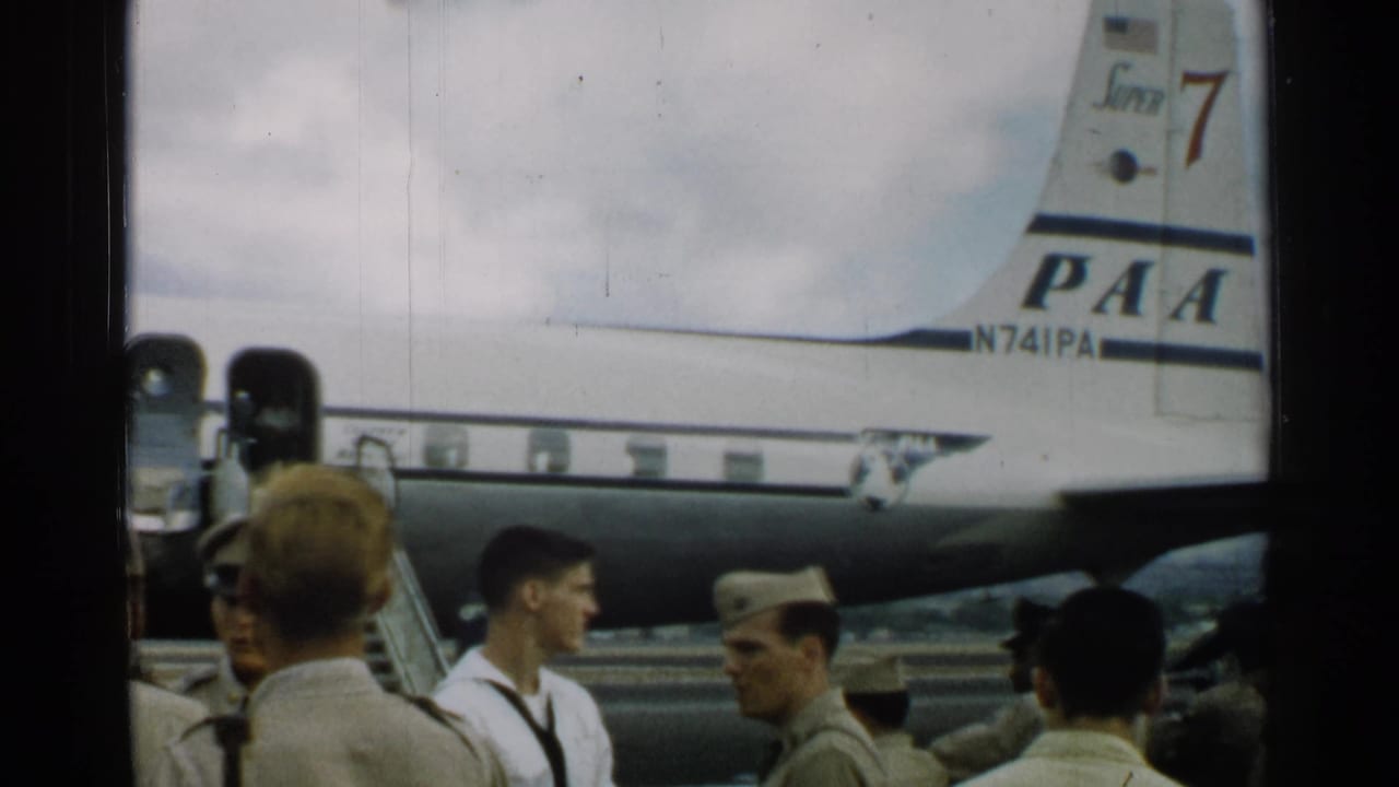 Uniformed men stand on a tarmac beside the tail of a PAA aircraft marked N741PA.