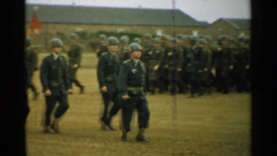 A closer 1952 New Hampshire view shows soldiers marching past the camera with a larger formation behind them.