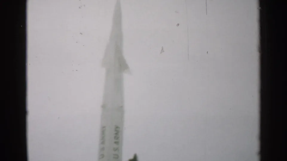 Close view of a tall white U.S. Army rocket against a cloudy sky, filmed in the same 1952 New Hampshire home-movie clip.