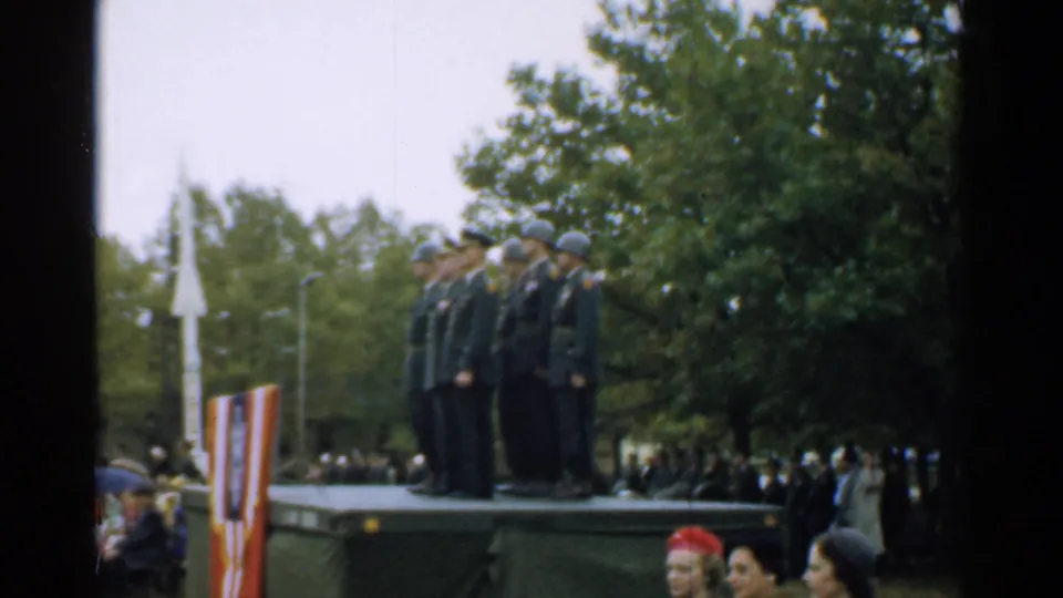 Raised platform with uniformed soldiers at a 1952 New Hampshire outdoor ceremony, with a tall white rocket-like display nearby.