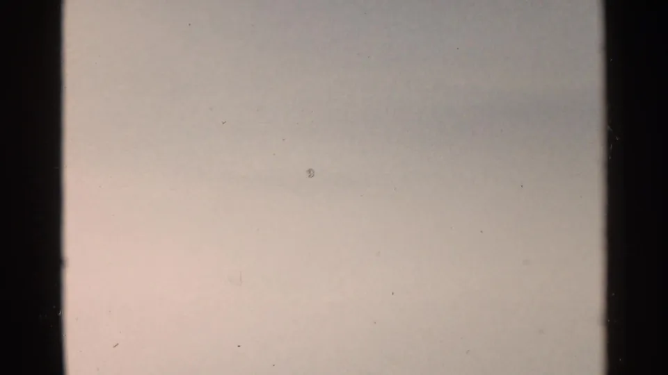 End frame from the 1953 Japan 8mm clip, showing a pale exposed area with dust and grain but no distinct subject.