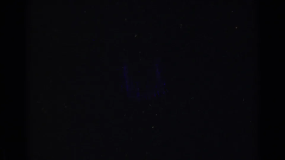 The lower-left contact-sheet frame is mostly dark, showing faint film grain and little readable scene detail.