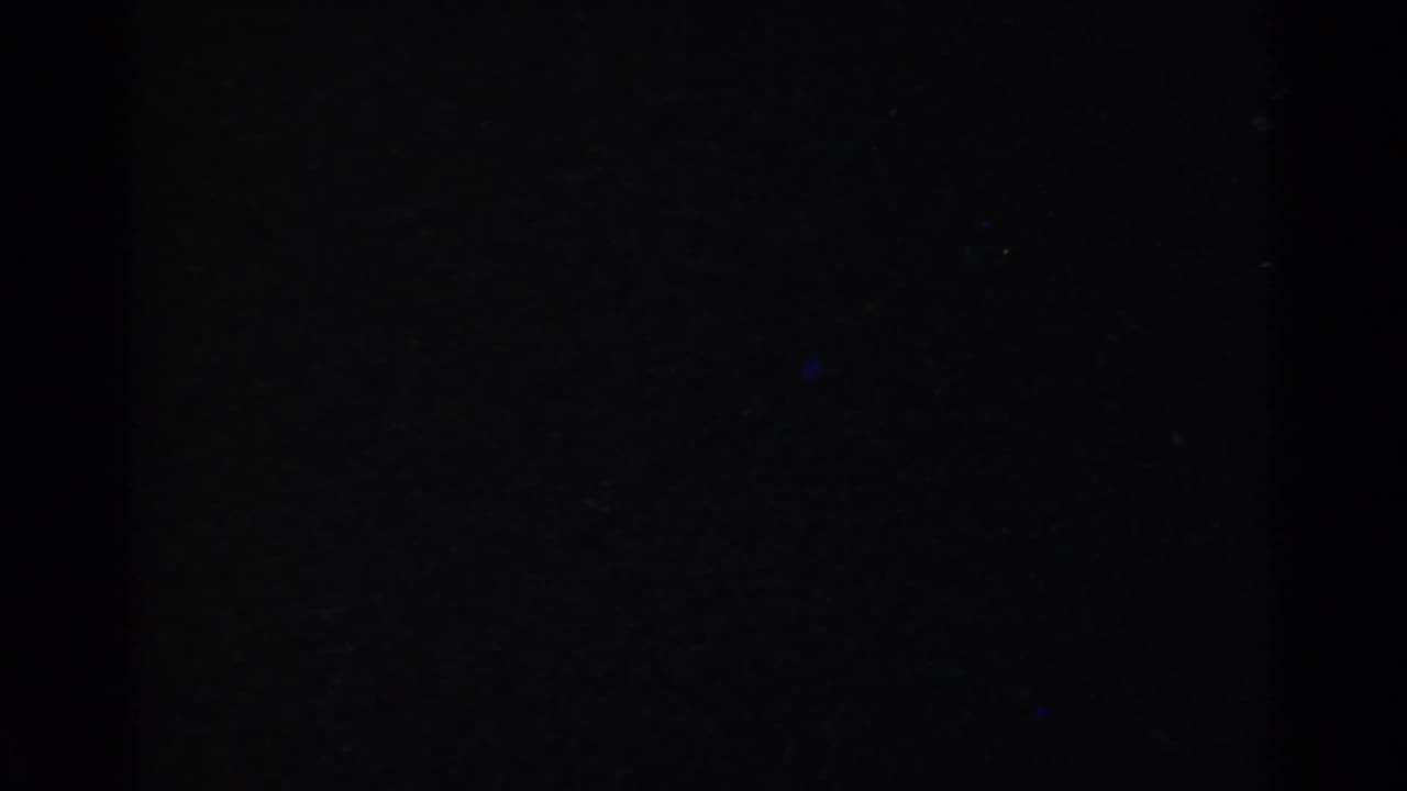 Mostly dark film frame with only faint exposure at the edges.