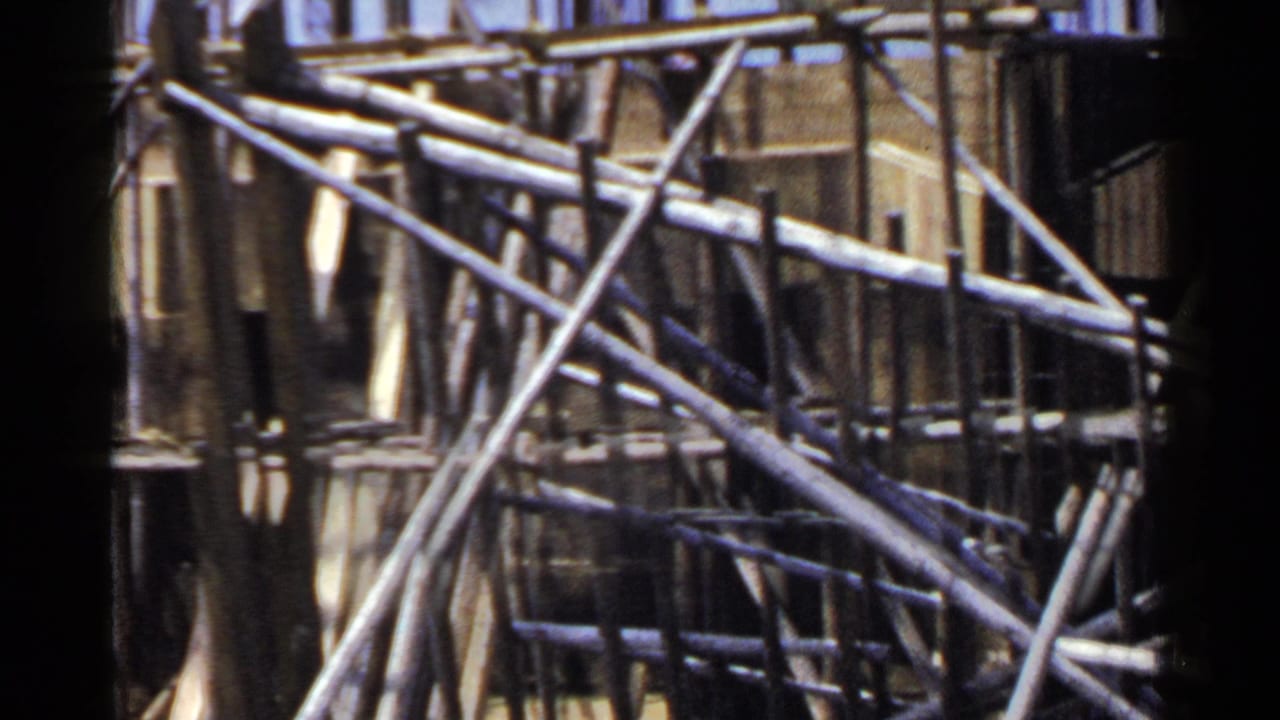 Close view of bamboo poles crossing a building facade.