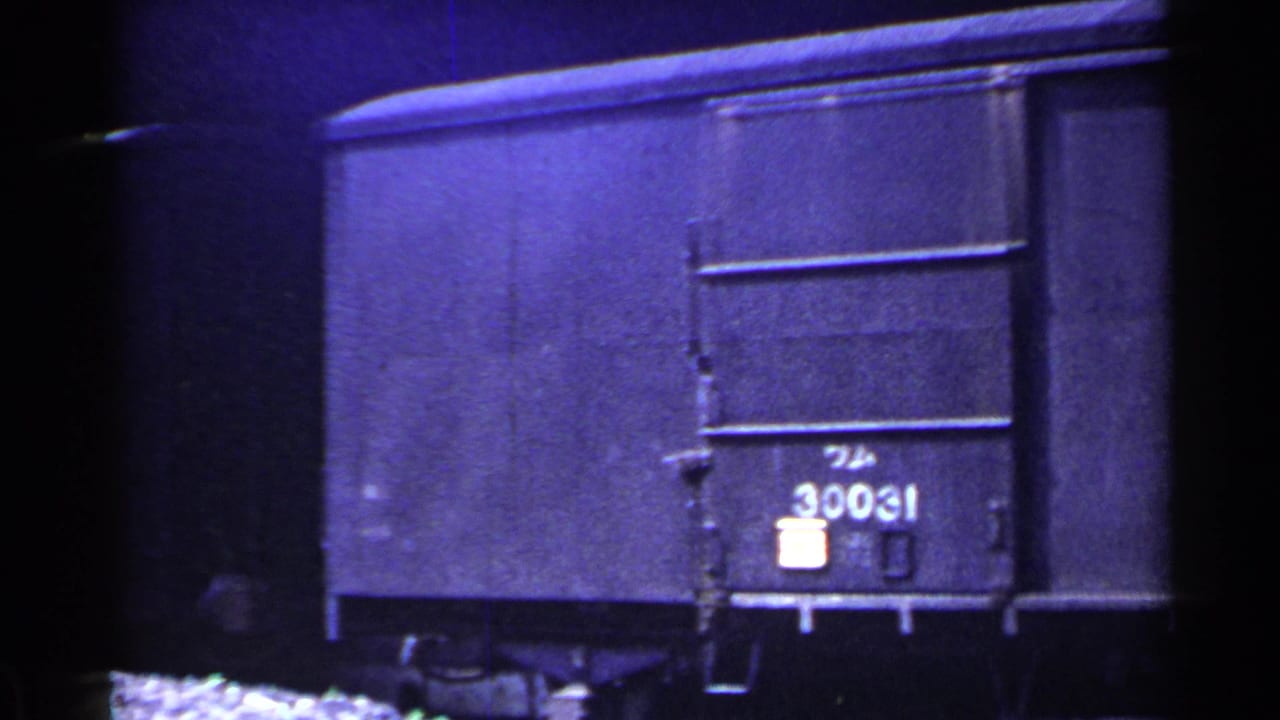 Freight car end with painted number 30031 visible in dim light.