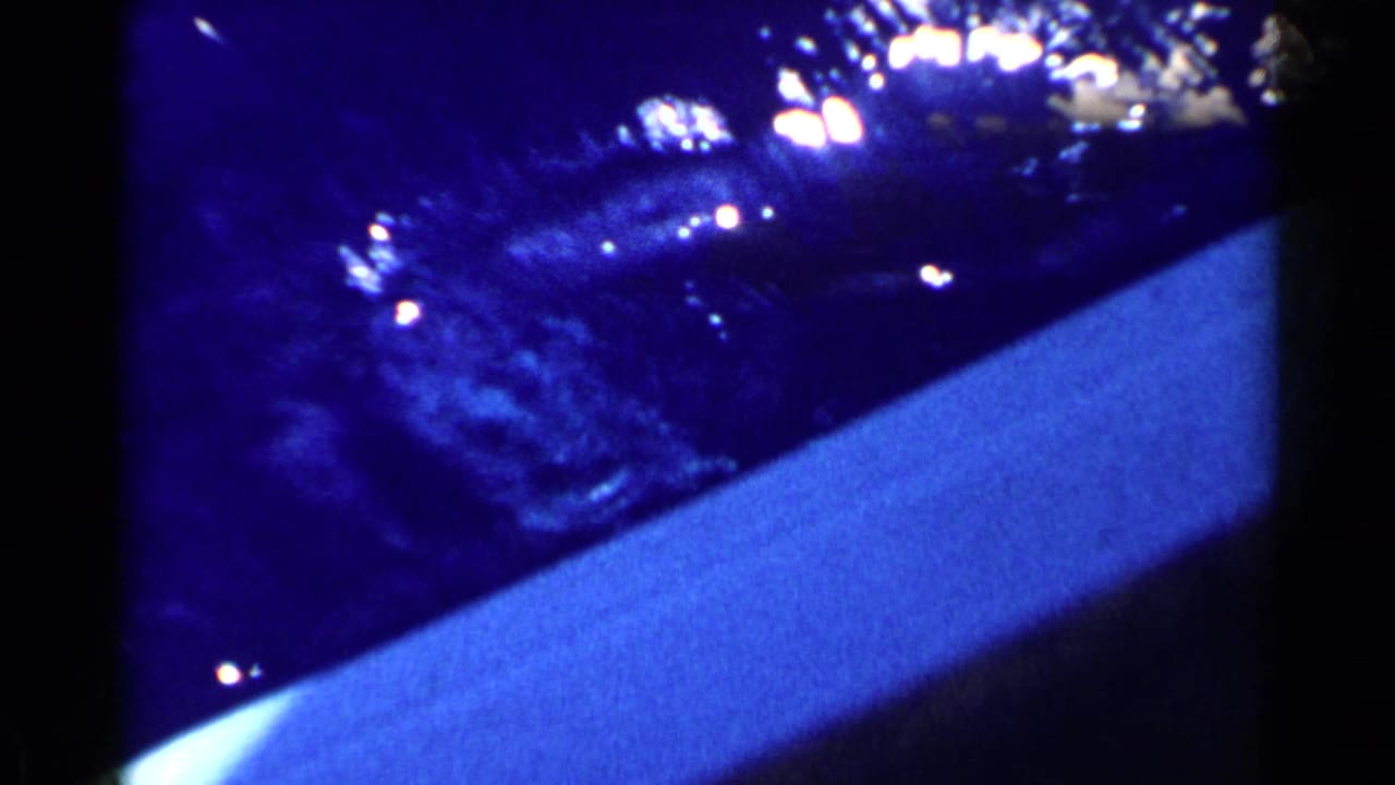 Blue underwater frame with bright reflections and a pale slanted surface.