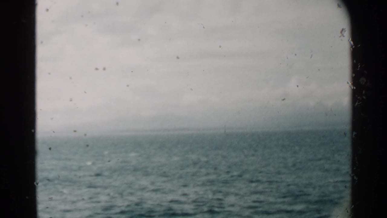 Pearl Harbor, Hawaii 1958 footage looking across rippled ocean water from inside or beside a moving vessel window.