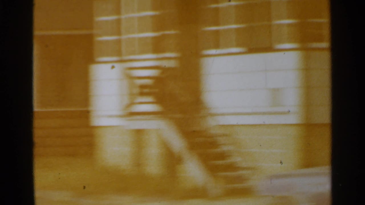 Blurred residential facade with stairs and warm yellow film color.