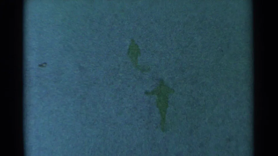 Two indistinct figures are visible in the South Dakota field, with one nearer the lower frame and one farther back.