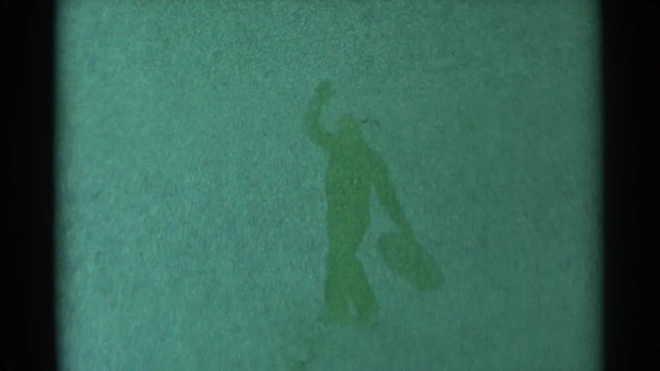 The sledder is low on the snowy ground with one arm raised, ending the brief 1959 South Dakota sledding mishap.