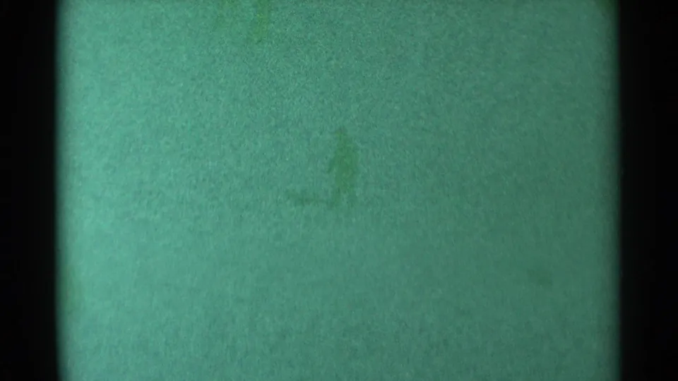 South Dakota 1959 home-movie frame showing small silhouetted people on a snow-covered hill.