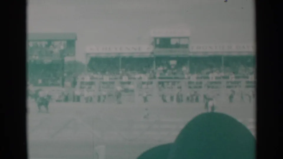 Cheyenne Frontier Days grandstand and arena activity seen from a spectator position in 1960 home-movie footage.