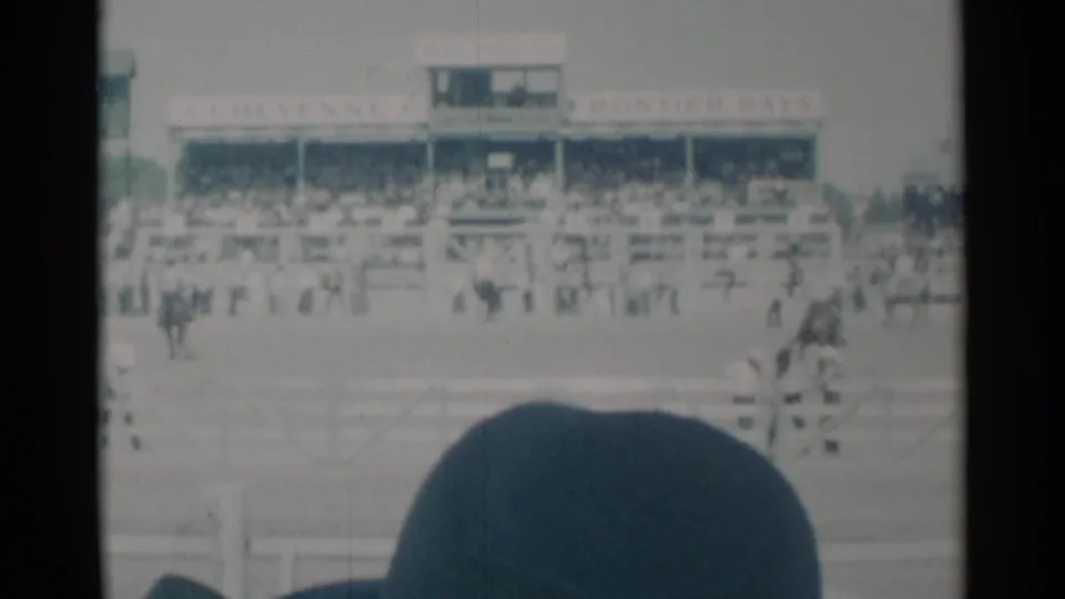 Cheyenne Frontier Days grandstand and track are visible in a 1960 8mm frame, with spectators and horses seen from the audience area.